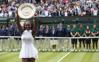 US player Serena Williams poses with the winner's trophy, the Venus Rosewater Dish, after her women's singles final victory over Germany's Angelique Kerber on the thirteenth day of the 2016 Wimbledon Championships at The All England Lawn Tennis Club in Wimbledon, southwest London, on July 9, 2016. / AFP / JUSTIN TALLIS / RESTRICTED TO EDITORIAL USE        (Photo credit should read JUSTIN TALLIS/AFP via Getty Images)