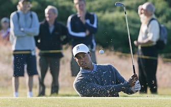Carnoustie, UNITED KINGDOM: US golfer Tiger Woods plays a shot from a bunker during a practice round prior to the 136th British Open Golf Championship at Carnoustie, in  Scotland, 17 July 2007. Tiger Woods will open his bid on Thursday to become just the second man in 125 years to win three straight British Open crowns in the company of Scotland's Paul Lawrie and Justin Rose of England. The world No.1 won at St Andrews in 2005 and Hoylake last year and he stands on the cusp of emulating Australian Peter Thomson, who became the only player to achieve a hat-trick of wins in the 20th century at Hoylake in 1956. AFP PHOTO/PAUL ELLIS (Photo credit should read PAUL ELLIS/AFP via Getty Images)