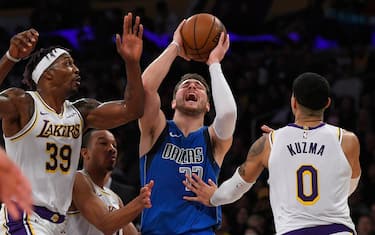 LOS ANGELES, CA - DECEMBER 29: Dwight Howard #39 of the Los Angeles Lakers fouls Luka Doncic #77 of the Dallas Mavericks while Kyle Kuzma #0 joins the play at Staples Center on December 29, 2019 in Los Angeles, California. NOTE TO USER: User expressly acknowledges and agrees that, by downloading and/or using this photograph, user is consenting to the terms and conditions of the Getty Images License Agreement. (Photo by John McCoy/Getty Images)