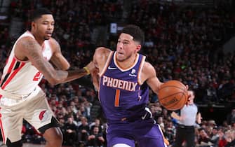 PORTLAND, OR - DECEMBER 30: Devin Booker #1 of the Phoenix Suns handles the ball against the Portland Trail Blazers on December 30, 2019 at the Moda Center Arena in Portland, Oregon. NOTE TO USER: User expressly acknowledges and agrees that, by downloading and or using this photograph, user is consenting to the terms and conditions of the Getty Images License Agreement. Mandatory Copyright Notice: Copyright 2019 NBAE (Photo by Sam Forencich/NBAE via Getty Images)