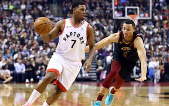 TORONTO, ON - DECEMBER 31:  Kyle Lowry #7 of the Toronto Raptors dribbles the ball as Dante Exum #1 of the Cleveland Cavaliers defends during the first half of an NBA game at Scotiabank Arena on December 31, 2019 in Toronto, Canada.  NOTE TO USER: User expressly acknowledges and agrees that, by downloading and or using this photograph, User is consenting to the terms and conditions of the Getty Images License Agreement.  (Photo by Vaughn Ridley/Getty Images)
