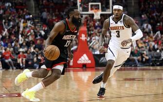 HOUSTON, TEXAS - DECEMBER 31: James Harden #13 of the Houston Rockets drives around Torrey Craig #3 of the Denver Nuggets during the second quarter at Toyota Center on December 31, 2019 in Houston, Texas. NOTE TO USER: User expressly acknowledges and agrees that, by downloading and/or using this photograph, user is consenting to the terms and conditions of the Getty Images License Agreement. (Photo by Bob Levey/Getty Images)