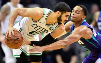 CHARLOTTE, NORTH CAROLINA - DECEMBER 31: Jayson Tatum #0 of the Boston Celtics keeps the ball away from PJ Washington #25 of the Charlotte Hornets during the second quarter during their game at Spectrum Center on December 31, 2019 in Charlotte, North Carolina. The Phoenix Suns top the Portland Trail Blazers 122-116. NOTE TO USER: User expressly acknowledges and agrees that, by downloading and or using this photograph, User is consenting to the terms and conditions of the Getty Images License Agreement. (Photo by Jacob Kupferman/Getty Images)