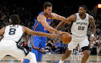 SAN ANTONIO, TX - NOVEMBER 07: Danilo Gallinari #8 of the Oklahoma City Thunder drives between Patty Mills #8 of the San Antonio Spurs and Rudy Gay #22 during an NBA game on November 7, 2019 at the AT&T Center in San Antonio, Texas. NOTE TO USER: User expressly acknowledges and agrees that, by downloading and or using this photograph, User is consenting to the terms and conditions of the Getty Images License Agreement.  (Photo by Edward A. Ornelas/Getty Images)