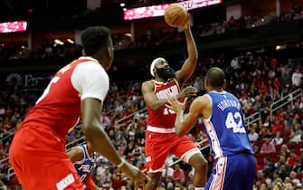 HOUSTON, TX - JANUARY 03:  James Harden #13 of the Houston Rockets passes the ball to Clint Capela #15 defended by Al Horford #42 of the Philadelphia 76ers in the second half at Toyota Center on January 3, 2020 in Houston, Texas.  NOTE TO USER: User expressly acknowledges and agrees that, by downloading and or using this photograph, User is consenting to the terms and conditions of the Getty Images License Agreement.  (Photo by Tim Warner/Getty Images)