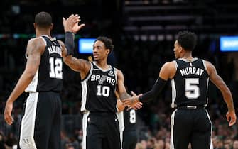 BOSTON, MASSACHUSETTS - JANUARY 08: DeMar DeRozan #10 of the San Antonio Spurs celebrates with LaMarcus Aldridge #12 and Dejounte Murray #5 during the game against the Boston Celtics at TD Garden on January 08, 2020 in Boston, Massachusetts. (Photo by Maddie Meyer/Getty Images)