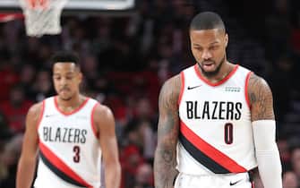 PORTLAND, OREGON - DECEMBER 21: Damian Lillard #0 reacts alongside CJ McCollum #3 of the Portland Trail Blazers in the first quarter against the Minnesota Timberwolves during their game at Moda Center on December 21, 2019 in Portland, Oregon. NOTE TO USER: User expressly acknowledges and agrees that, by downloading and or using this photograph, User is consenting to the terms and conditions of the Getty Images License Agreement (Photo by Abbie Parr/Getty Images) (Photo by Abbie Parr/Getty Images)
