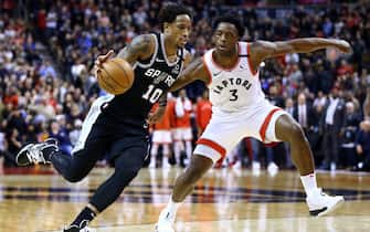 TORONTO, ON - JANUARY 12:  DeMar DeRozan #10 of the San Antonio Spurs dribbles the ball as OG Anunoby #3 of the Toronto Raptors defends during the second half of an NBA game at Scotiabank Arena on January 12, 2020 in Toronto, Canada.  NOTE TO USER: User expressly acknowledges and agrees that, by downloading and or using this photograph, User is consenting to the terms and conditions of the Getty Images License Agreement.  (Photo by Vaughn Ridley/Getty Images)