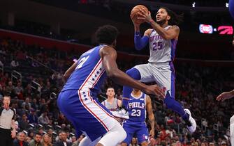 DETROIT, MICHIGAN - DECEMBER 23: Derrick Rose #25 of the Detroit Pistons drives to the basket against Joel Embiid #21 of the Philadelphia 76ers during the first half at Little Caesars Arena on December 23, 2019 in Detroit, Michigan.  NOTE TO USER: User expressly acknowledges and agrees that, by downloading and or using this photograph, User is consenting to the terms and conditions of the Getty Images License Agreement. (Photo by Gregory Shamus/Getty Images)