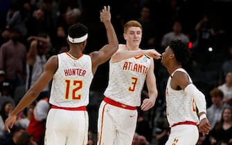 SAN ANTONIO, TX - JANUARY 17:  Kevin Huerter #3  of the Atlanta Hawks celebrates his game winning three with De'Andre Hunter #12 and Cam Reddish #22 during second half action at AT&T Center on January 17, 2020 in San Antonio, Texas.  Atlanta Hawks defeated the San Antonio Spurs 121-120. NOTE TO USER: User expressly acknowledges and agrees that ,by downloading and or using this photograph, User is consenting to the terms and conditions of the Getty Images License Agreement. (Photo by Ronald Cortes/Getty Images)