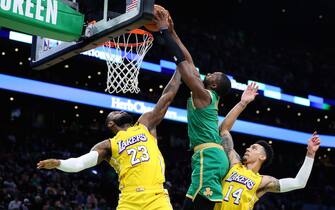 BOSTON, MASSACHUSETTS - JANUARY 20: Jaylen Brown #7 of the Boston Celtics dunks over LeBron James #23 and Danny Green #14 of the Los Angeles Lakers at TD Garden on January 20, 2020 in Boston, Massachusetts. The Celtics defeat the Lakers 139-107.  (Photo by Maddie Meyer/Getty Images)