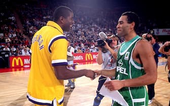 PARIS, FRANCE - OCTOBER 18: Magic Johnson #32 of the Los Angeles Lakers greets a player from Limoges during the 1991 McDonalds Open on October 18, 1991 at the Palais Omnisports de Paris-Bercy in Paris France. The Los Angeles Lakers defeated Limoges 132-101. NOTE TO USER: User expressly acknowledges and agrees that, by downloading and/or using this Photograph, user is consenting to the terms and conditions of the Getty Images License Agreement. Mandatory Copyright Notice: Copyright 1991 NBAE (Photo by Andrew D. Bernstein/NBAE via Getty Images)
