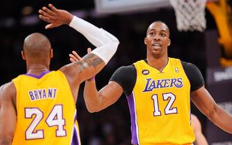 LOS ANGELES, CA - APRIL 12: Kobe Bryant #24 and Dwight Howard #12 of the Los Angeles Lakers celebrate during their game against the Golden State Warriors at Staples Center on April 12, 2013 in Los Angeles, California. NOTE TO USER: User expressly acknowledges and agrees that, by downloading and/or using this Photograph, user is consenting to the terms and conditions of the Getty Images License Agreement. Mandatory Copyright Notice: Copyright 2013 NBAE (Photo by Noah Graham/NBAE via Getty Images)