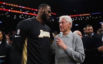 NEW YORK, NEW YORK - JANUARY 23:  Former U.S. President Bill Clinton speaks with LeBron James #23 of the Los Angeles Lakers following the game against the Brooklyn Nets at Barclays Center on January 23, 2020 in New York City. NOTE TO USER: User expressly acknowledges and agrees that, by downloading and or using this photograph, User is consenting to the terms and conditions of the Getty Images License Agreement.  (Photo by Mike Stobe/Getty Images)