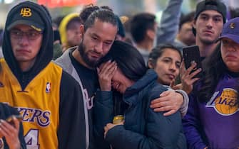 LOS ANGELES, CA - JANUARY 26: People mourn for former NBA star Kobe Bryant, who was killed in a helicopter crash in Calabasas, California, near Staples Center on January 26, 2020 in Los Angeles, California. Nine people have been confirmed dead in the crash, among them Bryant and his 13-year-old daughter Gianna. (Photo by David McNew/Getty Images)
