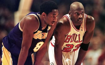 CHICAGO, UNITED STATES:  Los Angeles Lakers guard Kobe Bryant(L) and Chicago Bulls guard Michael Jordan(R) talk during a free-throw attempt during the fourth quarter 17 December at the United Center in Chicago. Bryant, who is 19 and bypassed college basketball to play in the NBA, scored a team-high 33 points off the bench, and Jordan scored a team-high 36 points. The Bulls defeated the Lakers 104-83.  AFP PHOTO  VINCENT LAFORET (Photo credit should read VINCENT LAFORET/AFP via Getty Images)