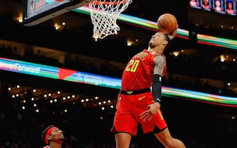 ATLANTA, GEORGIA - JANUARY 26:  John Collins #20 of the Atlanta Hawks dunks against Bradley Beal #3 of the Washington Wizards in the second half at State Farm Arena on January 26, 2020 in Atlanta, Georgia.  NOTE TO USER: User expressly acknowledges and agrees that, by downloading and/or using this photograph, user is consenting to the terms and conditions of the Getty Images License Agreement.  (Photo by Kevin C. Cox/Getty Images)