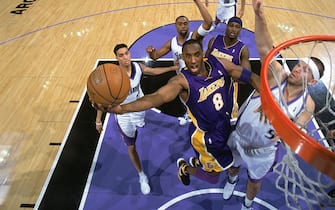 SACRAMENTO, CA - JANUARY 19:  Kobe Bryant #8 of the Los Angeles Lakers goes for the layup against Brad Miller #52 of the Sacramento Kings at Arco Arena on January 19, 2006 in Sacramento, California. The Kings won 118-109 in OT. NOTE TO USER: User expressly acknowledges and agrees that, by downloading and/or using this Photograph, user is consenting to the terms and conditions of the Getty Images License Agreement. Mandatory Copyright Notice: Copyright 2006 NBAE (Photo by Rocky Widner/NBAE via Getty Images)
