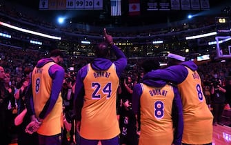 LOS ANGELES, CALIFORNIA - JANUARY 31:  (L-R) Anthony Davis, LeBron James, Quinn Cook and Kentavious Caldwell-Pope of the Los Angeles Lakers reacts at the end of the National Anthem during a ceremony to honor Kobe Bryant before the game against the Portland Trail Blazers at Staples Center on January 31, 2020 in Los Angeles, California. (Photo by Harry How/Getty Images)