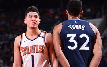 PHOENIX, AZ - NOVEMBER 11:  Devin Booker #1 of the Phoenix Suns and Karl-Anthony Towns #32 of the Minnesota Timberwolves during the game on November 11, 2017 at Talking Stick Resort Arena in Phoenix, Arizona. NOTE TO USER: User expressly acknowledges and agrees that, by downloading and or using this photograph, user is consenting to the terms and conditions of the Getty Images License Agreement. Mandatory Copyright Notice: Copyright 2017 NBAE (Photo by Michael Gonzales/NBAE via Getty Images)