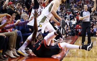 1198878355 TORONTO, ON - FEBRUARY 05: Serge Ibaka #9 of the Toronto Raptors is knocked down by Domantas Sabonis #11 of the Indiana Pacers after sinking the game-winning three pointer during the second half of an NBA game at Scotiabank Arena on February 05, 2020 in Toronto, Canada. The Raptors defeated the Pacers 119-118. NOTE TO USER: User expressly acknowledges and agrees that, by downloading and or using this photograph, User is consenting to the terms and conditions of the Getty Images License Agreement. (Photo by Vaughn Ridley/Getty Images)