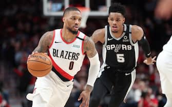 1204541765 PORTLAND, OREGON - FEBRUARY 06: Damian Lillard #0 of the Portland Trail Blazers dribbles against Dejounte Murray #5 of the San Antonio Spurs in the third quarter during their game at Moda Center on February 06, 2020 in Portland, Oregon. NOTE TO USER: User expressly acknowledges and agrees that, by downloading and or using this photograph, User is consenting to the terms and conditions of the Getty Images License Agreement. (Photo by Abbie Parr/Getty Images)