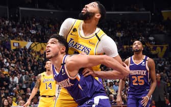 LOS ANGELES, CA - FEBRUARY 10: Devin Booker #1 of the Phoenix Suns and Anthony Davis #3 of the Los Angeles Lakers fight for position during the game on February 10, 2020 at STAPLES Center in Los Angeles, California. NOTE TO USER: User expressly acknowledges and agrees that, by downloading and/or using this Photograph, user is consenting to the terms and conditions of the Getty Images License Agreement. Mandatory Copyright Notice: Copyright 2020 NBAE (Photo by Andrew D. Bernstein/NBAE via Getty Images) 