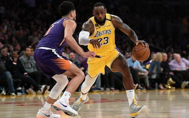 LOS ANGELES, CA - FEBRUARY 10: LeBron James #23 of the Los Angeles Lakers drives against Devin Booker #1 of the Phoenix Suns during the first half at Staples Center on February 10, 2020 in Los Angeles, California. NOTE TO USER: User expressly acknowledges and agrees that, by downloading and/or using this Photograph, user is consenting to the terms and conditions of the Getty Images License Agreement. (Photo by Kevork Djansezian/Getty Images)