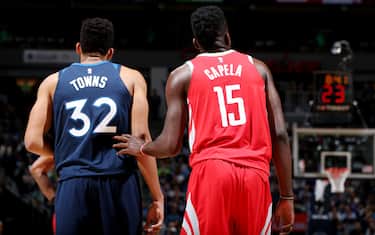 MINNEAPOLIS, MN -  APRIL 21:  Karl-Anthony Towns #32 of the Minnesota Timberwolves and Clint Capela #15 of the Houston Rockets look on during Game Three of Round One of the 2018 NBA Playoffs on April 21, 2018 at Target Center in Minneapolis, Minnesota. NOTE TO USER: User expressly acknowledges and agrees that, by downloading and or using this Photograph, user is consenting to the terms and conditions of the Getty Images License Agreement. Mandatory Copyright Notice: Copyright 2018 NBAE (Photo by David Sherman/NBAE via Getty Images)
