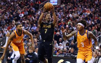 TORONTO, ON - FEBRUARY 21:  Kyle Lowry #7 of the Toronto Raptors shoots the ball as Kelly Oubre Jr. #3 of the Phoenix Suns defends during the first half of an NBA game at Scotiabank Arena on February 21, 2020 in Toronto, Canada.  NOTE TO USER: User expressly acknowledges and agrees that, by downloading and or using this photograph, User is consenting to the terms and conditions of the Getty Images License Agreement.  (Photo by Vaughn Ridley/Getty Images)