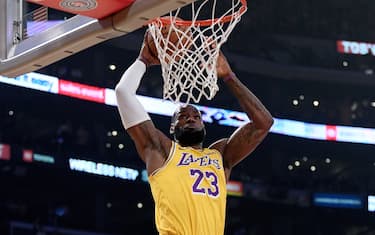 LOS ANGELES, CALIFORNIA - FEBRUARY 21:  LeBron James #23 of the Los Angeles Lakers dunks in front of Dillon Brooks #24 of the Memphis Grizzlies during the first quarter at Staples Center on February 21, 2020 in Los Angeles, California.  NOTE TO USER: User expressly acknowledges and agrees that, by downloading and or using this photograph, User is consenting to the terms and conditions of the Getty Images License Agreement. (Photo by Harry How/Getty Images)