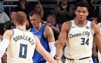 1189043672 MILWAUKEE, WI - DECEMBER 16: Giannis Antetokounmpo #34 of the Milwaukee Bucks high fives Donte DiVincenzo #0 during the game against the Dallas Mavericks on December 16, 2019 at the Fiserv Forum Center in Milwaukee, Wisconsin. NOTE TO USER: User expressly acknowledges and agrees that, by downloading and or using this Photograph, user is consenting to the terms and conditions of the Getty Images License Agreement. Mandatory Copyright Notice: Copyright 2019 NBAE (Photo by Gary Dineen/NBAE via Getty Images).