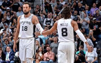 SAN ANTONIO, TX - APRIL 25:  Marco Belinelli #18 hi-fives Patty Mills #8 of the San Antonio Spurs during Game Six of Round One of the 2019 NBA Playoffs on April 25, 2019 at the AT&T Center in San Antonio, Texas. NOTE TO USER: User expressly acknowledges and agrees that, by downloading and/or using this photograph, user is consenting to the terms and conditions of the Getty Images License Agreement. Mandatory Copyright Notice: Copyright 2019 NBAE (Photos by Mark Sobhani/NBAE via Getty Images)