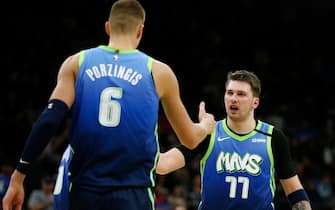 SAN ANTONIO, TX - FEBRUARY 26:  Luka Doncic #77 of the Dallas Mavericks congratulates teammate Kristaps Porzingis #6 on scoring against the San Antonio Spurs during second-half action at AT&T Center on February  26, 2020 in San Antonio, Texas. The Mavs defeated the Spurs 109-103. NOTE TO USER: User expressly acknowledges and agrees that , by downloading and or using this photograph, User is consenting to the terms and conditions of the Getty Images License Agreement. (Photo by Ronald Cortes/Getty Images)
