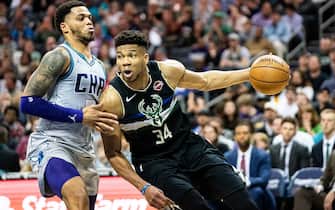 1209734343 CHARLOTTE, NORTH CAROLINA - MARCH 01: Giannis Antetokounmpo #34 of the Milwaukee Bucks tries to dribble around Miles Bridges #0 of the Charlotte Hornets during the fourth quarter during their game at Spectrum Center on March 01, 2020 in Charlotte, North Carolina. NOTE TO USER: User expressly acknowledges and agrees that, by downloading and/or using this photograph, user is consenting to the terms and conditions of the Getty Images License Agreement. (Photo by Jacob Kupferman/Getty Images)