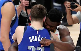 DALLAS, TEXAS - MARCH 04: Luka Doncic #77 of the Dallas Mavericks hugs Zion Williamson #1 of the New Orleans Pelicans after the Dallas Mavericks beat the New Orleans Pelicans 127-123 in overtime at American Airlines Center on March 04, 2020 in Dallas, Texas. NOTE TO USER: User expressly acknowledges and agrees that, by downloading and or using this photograph, User is consenting to the terms and conditions of the Getty Images License Agreement. (Photo by Tom Pennington/Getty Images)