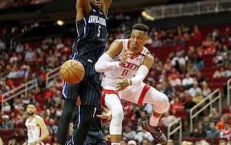 HOUSTON, TEXAS - MARCH 08: Russell Westbrook #0 of the Houston Rockets passes the ball under the basket while defended by Mo Bamba #5 of the Orlando Magic in the second half at Toyota Center on March 08, 2020 in Houston, Texas.  NOTE TO USER: User expressly acknowledges and agrees that, by downloading and or using this photograph, User is consenting to the terms and conditions of the Getty Images License Agreement. (Photo by Tim Warner/Getty Images)