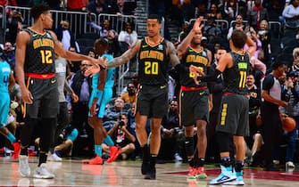 ATLANTA, GA - MARCH 9: John Collins #20 of the Atlanta Hawks high fives his teammates during the game against the Charlotte Hornets on March 9, 2020 at State Farm Arena in Atlanta, Georgia.  NOTE TO USER: User expressly acknowledges and agrees that, by downloading and/or using this Photograph, user is consenting to the terms and conditions of the Getty Images License Agreement. Mandatory Copyright Notice: Copyright 2020 NBAE (Photo by Scott Cunningham/NBAE via Getty Images)