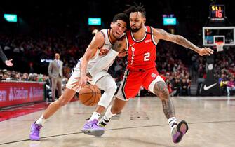 PORTLAND, OREGON - MARCH 10: Devin Booker #1 of the Phoenix Suns if fouled by Gary Trent Jr. #2 of the Portland Trail Blazers during the first half of the game at the Moda Center on March 10, 2020 in Portland, Oregon. The Portland Trail Blazers topped the Phoenix Suns, 121-105. NOTE TO USER: User expressly acknowledges and agrees that, by downloading and or using this photograph, User is consenting to the terms and conditions of the Getty Images License Agreement. (Photo by Alika Jenner/Getty Images)
