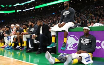 BOSTON, MASSACHUSETTS - JANUARY 20: LeBron James #23 and Kentavious Caldwell-Pope #1 of the Los Angeles Lakers look on from the bench during the game against the Boston Celtics at TD Garden on January 20, 2020 in Boston, Massachusetts. The Celtics defeat the Lakers 139-107.  (Photo by Maddie Meyer/Getty Images)