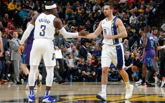 1188982977 INDIANAPOLIS, IN - DECEMBER 15: Aaron Holiday #3 and T.J. McConnell #9 of the Indiana Pacers hi-five during a game against the Charlotte Hornets on December 15, 2019 at Bankers Life Fieldhouse in Indianapolis, Indiana. NOTE TO USER: User expressly acknowledges and agrees that, by downloading and or using this Photograph, user is consenting to the terms and conditions of the Getty Images License Agreement. Mandatory Copyright Notice: Copyright 2019 NBAE (Photo by Ron Hoskins/NBAE via Getty Images)
