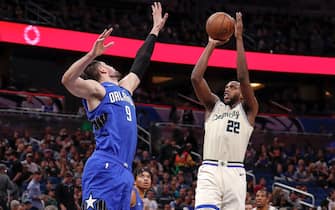 1204959004 ORLANDO, FL - FEBRUARY 8: Khris Middleton #22 of the Milwaukee Bucks is defended by Nikola Vucevic #9 of the Orlando Magic during the game at the Amway Center on February 8, 2020 in Orlando, Florida. The Bucks defeated the Magic 112 to 95. NOTE TO USER: User expressly acknowledges and agrees that, by downloading and or using this photograph, User is consenting to the terms and conditions of the Getty Images License Agreement. (Photo by Don Juan Moore/Getty Images) *** Local Caption *** Khris Middleton; Nikola Vucevic