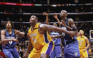 LOS ANGELES - DECEMBER 1:  Shaquille O'Neal #34 of the Los Angeles Lakers looks for the rebound as he guards Kevin Garnett #21 of the Minnesota Timberwolves at Staples Center on December 1, 2002 in Los Angeles, California. The Timberwolves won 110-107.NOTE TO USER: User expressly acknowledges and agrees that, by downloading and/or using this Photograph, User is consenting to the terms and conditions of the Getty Images License Agreement. Mandatory copyright notice:  Copyright 2002 NBAE (Photo by: Andrew D Bernstein/NBAE via Getty Images)