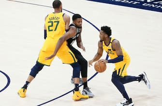 SALT LAKE CITY, UT - FEBRUARY 21: Donovan Mitchell #45 of the Utah Jazz drives past Rudy Gay #22 of the San Antonio Spurs on a screen set by Rudy Gobert #27 of the Utah Jazz during a game at the Vivint Smart Home Arena on February 21, 2020 in Salt Lake City, UT. NOTE TO USER: User expressly acknowledges and agrees that, by downloading and or using this photograph, User is consenting to the terms and conditions of the Getty Images License Agreement. Mandatory Credit: 2020 NBAE (Photo by Chris Elise/NBAE via Getty Images)