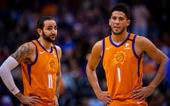 PHOENIX, AZ - JANUARY 31: Ricky Rubio #11 and Devin Booker #1 of the Phoenix Suns look on during the game against the Oklahoma City Thunder on January 31, 2020 at Talking Stick Resort Arena in Phoenix, Arizona. NOTE TO USER: User expressly acknowledges and agrees that, by downloading and or using this photograph, user is consenting to the terms and conditions of the Getty Images License Agreement. Mandatory Copyright Notice: Copyright 2020 NBAE (Photo by Zach Beeker/NBAE via Getty Images)