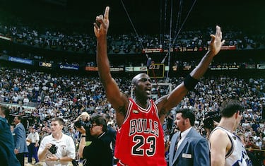 SALT LAKE CITY - JUNE 14:  Michael Jordan #23 of the Chicago Bulls raises his hands to signal a 6th championship as he leaves the court after winning the NBA Championpship against the Utah at the Delta Center on June 14, 1998 in Salt Lake City, Utah. The Bulls won 87-86.  NOTE TO USER: User expressly acknowledges  and agrees that, by downloading and or using this  photograph, User is consenting to the terms and conditions of the Getty Images License Agreement. (Photo by Nathaniel S. Butler/ NBAE via Getty Images)