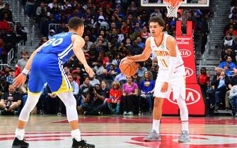 ATLANTA, GA - DECEMBER 3: Trae Young #11 of the Atlanta Hawks dribbles the ball during the game against Stephen Curry #30 of the Golden State Warriors on December 3, 2018 at State Farm Arena in Atlanta, Georgia.  NOTE TO USER: User expressly acknowledges and agrees that, by downloading and/or using this Photograph, user is consenting to the terms and conditions of the Getty Images License Agreement. Mandatory Copyright Notice: Copyright 2018 NBAE (Photo by Scott Cunningham/NBAE via Getty Images)
