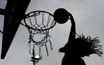 1062365060 US basketball dunker Justin Darlington of the Court Kingz streetball basketball fundraiser team performs at the 23 de Enero neighbourhood in Caracas on November 15, 2018. (Photo by Federico PARRA / AFP) (Photo credit should read FEDERICO PARRA/AFP via Getty Images)