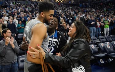 MINNEAPOLIS, MN - APRIL 11: Karl-Anthony Towns #32 of the Minnesota Timberwolves hugs his parents, Karl and Jackie Towns after winning the game against the Denver Nuggets of the game on April 11, 2018 at the Target Center in Minneapolis, Minnesota. The Timberwolves defeated the Nuggets 112-106. NOTE TO USER: User expressly acknowledges and agrees that, by downloading and or using this Photograph, user is consenting to the terms and conditions of the Getty Images License Agreement. (Photo by Hannah Foslien/Getty Images)