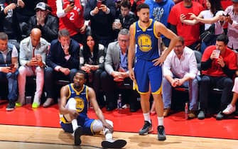 TORONTO, CANADA - JUNE 10: Kevin Durant #35 of the Golden State Warriors reacts to his leg injury during a game against the Toronto Raptors during Game Five of the NBA Finals on June 10, 2019 at Scotiabank Arena in Toronto, Ontario, Canada. NOTE TO USER: User expressly acknowledges and agrees that, by downloading and/or using this photograph, user is consenting to the terms and conditions of the Getty Images License Agreement. Mandatory Copyright Notice: Copyright 2019 NBAE (Photo by Jesse D. Garrabrant/NBAE via Getty Images)